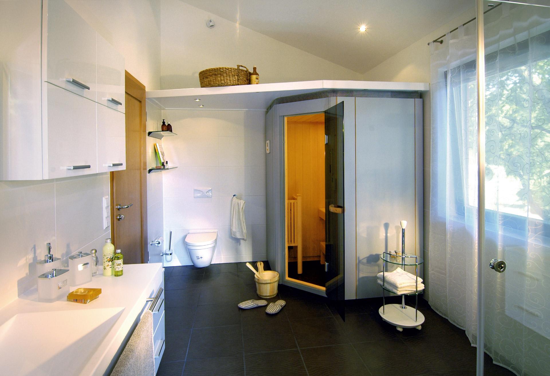 Baño de bienestar con sauna, lavabo doble y ducha